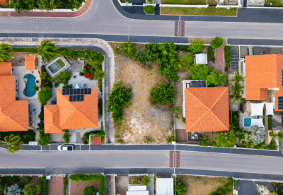 Luchtfoto van luxe woningen en tuinen in Jan Sofat, met zwembaden en groene tuinen.